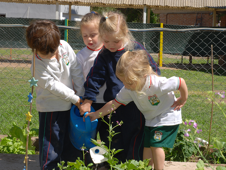 Alumnos regando la huerta del colegio